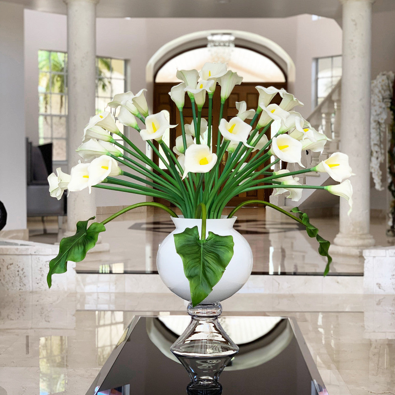 Refine vase with multiple white calla lilies