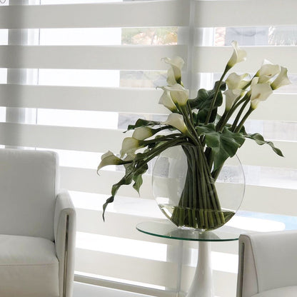 Moon vase with white calla lilies