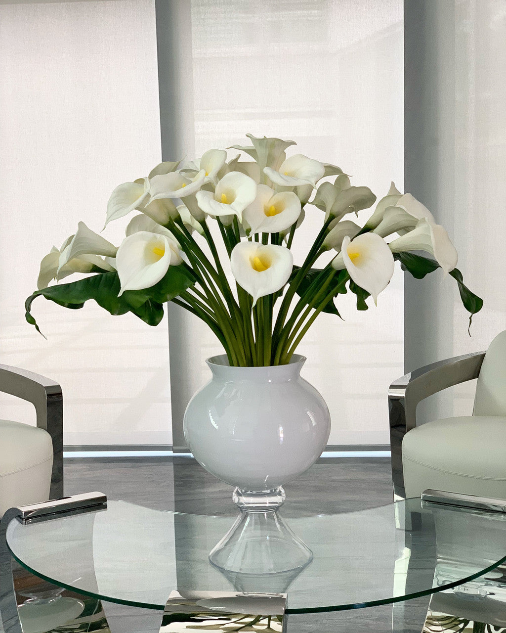 Refine vase with multiple white calla lilies