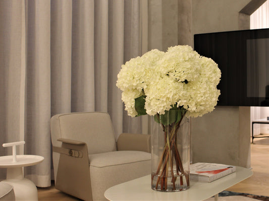 White Hydrangea Bouquet in clear tall glass cylinder vase